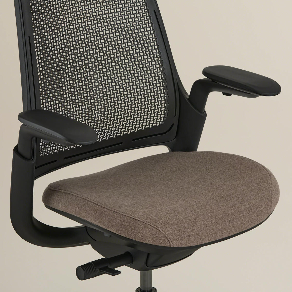 Close-up of the chair's seat and base with adjustment lever visible.