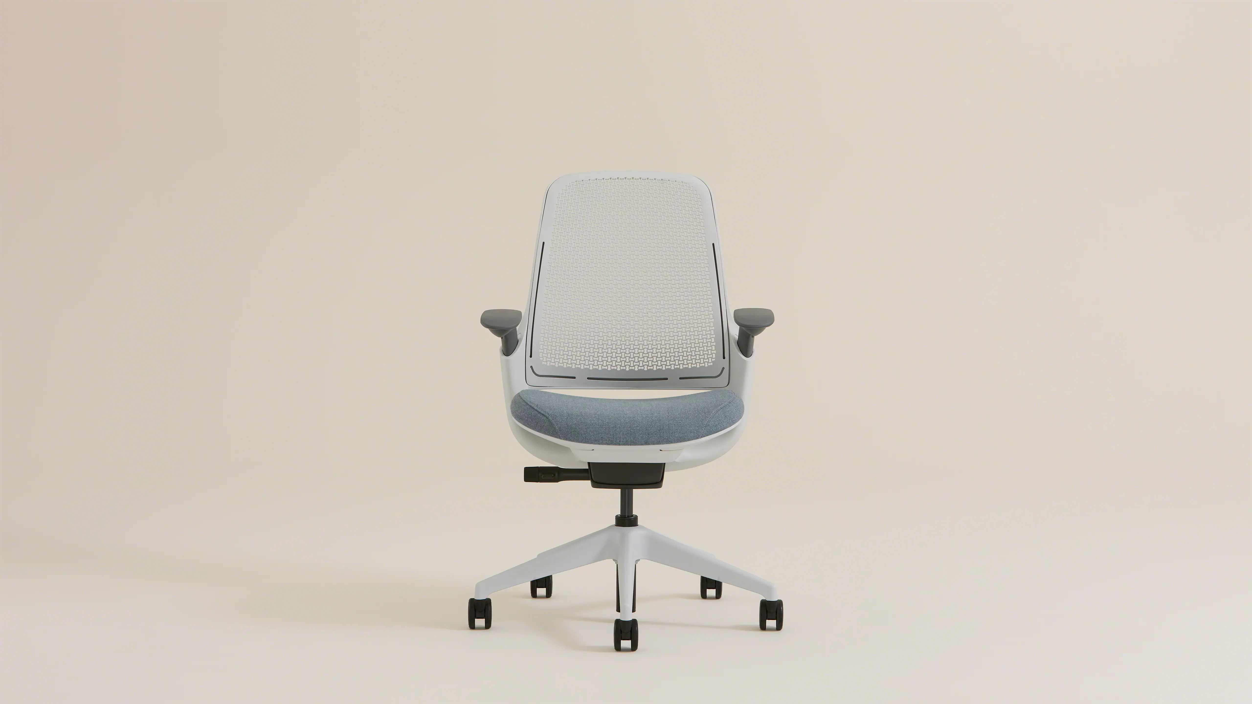 Modern ergonomic office chair with white frame, light gray mesh back, and blue cushioned seat.